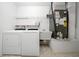 Laundry room with washer, dryer, shelving and utility sink at 17789 Se 113Th Ter, Summerfield, FL 34491