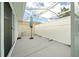 Screened patio with grey flooring and white privacy fence at 17789 Se 113Th Ter, Summerfield, FL 34491