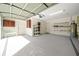 Garage with storage shelving and automatic garage door opener at 17789 Se 113Th Ter, Summerfield, FL 34491
