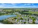 Aerial view of a house with solar panels near a lake and golf course at 17789 Se 113Th Ter, Summerfield, FL 34491