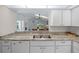 Kitchen features granite countertops, double sink and a view to living room at 17789 Se 113Th Ter, Summerfield, FL 34491