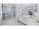 Bathroom with double vanity, shower, and tile flooring at 17789 Se 113Th Ter, Summerfield, FL 34491