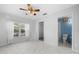 Bedroom with tile floors, ceiling fan and en-suite bathroom at 17789 Se 113Th Ter, Summerfield, FL 34491