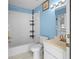 Light blue bathroom with a bathtub, toilet and sink at 17789 Se 113Th Ter, Summerfield, FL 34491