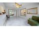 Bright sunroom with tiled floors, a ceiling fan, and sliding glass doors at 17789 Se 113Th Ter, Summerfield, FL 34491