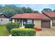 House exterior featuring a brown roof, light beige walls, and a well-maintained lawn at 4961 Sw 196Th Ave, Dunnellon, FL 34431