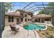 Inviting pool area with a covered patio and lounge chairs at 678 Se 47Th Loop, Ocala, FL 34480