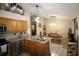 Kitchen with island, stainless steel appliances and wood cabinets at 727 Ne 130Th Ter, Silver Springs, FL 34488