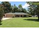 Single story home with green roof and attached garage at 727 Ne 130Th Ter, Silver Springs, FL 34488