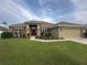 One-story house with red shutters and a two-car garage at 9115 Sw 49Th Ct, Ocala, FL 34476