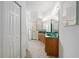 Bathroom with double vanity, shower, and tile flooring at 11700 Sw 72Nd Cir, Ocala, FL 34476