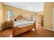 Main bedroom with hardwood floors and a large bed at 11700 Sw 72Nd Cir, Ocala, FL 34476