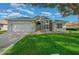 One-story home with attached garage and a spacious front yard at 11700 Sw 72Nd Cir, Ocala, FL 34476