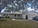 Single-story home with a two-car garage and mature landscaping at 6484 Sw 111Th Pl, Ocala, FL 34476