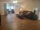 Living room features a sliding glass door and laminate flooring at 6484 Sw 111Th Pl, Ocala, FL 34476