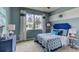 Spacious bedroom featuring a stylish bed and blue color scheme at 8563 Pinecrest Trl, Wildwood, FL 34785