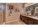 Elegant bathroom with double vanity, granite countertop, and large shower at 8563 Pinecrest Trl, Wildwood, FL 34785