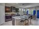 Modern kitchen with granite island, dark cabinetry, and stainless steel appliances at 8563 Pinecrest Trl, Wildwood, FL 34785