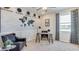 Home office featuring a desk, comfortable chair, and world map accent wall at 8563 Pinecrest Trl, Wildwood, FL 34785