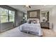 Spacious main bedroom with large bed and gray color scheme at 8563 Pinecrest Trl, Wildwood, FL 34785