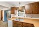 Kitchen features wood cabinets, double sink, and window view at 1335 Ne 33Rd St, Ocala, FL 34479
