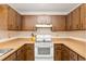 Bright kitchen with wood cabinets and white appliances at 1335 Ne 33Rd St, Ocala, FL 34479