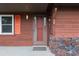 Red front door with screen and small welcome mat at 1335 Ne 33Rd St, Ocala, FL 34479