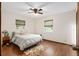 Bright bedroom with wood floors, ceiling fan, and window coverings at 1335 Ne 33Rd St, Ocala, FL 34479