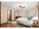 Main bedroom with ceiling fan, wood floors and en-suite bathroom at 1335 Ne 33Rd St, Ocala, FL 34479