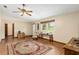 Spacious living room with hardwood floors, ceiling fan, and large windows at 1335 Ne 33Rd St, Ocala, FL 34479