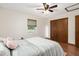 Bedroom with wood floors, ceiling fan, and double door closet at 1335 Ne 33Rd St, Ocala, FL 34479