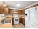 Bright kitchen with wood cabinets, white appliances, and a double sink at 1335 Ne 33Rd St, Ocala, FL 34479