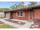 House entrance with orange shutters and rock landscaping at 1335 Ne 33Rd St, Ocala, FL 34479