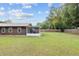 Backyard view of home and screened porch at 1335 Ne 33Rd St, Ocala, FL 34479