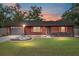 House exterior at sunset, with wood siding and landscaping at 1335 Ne 33Rd St, Ocala, FL 34479