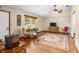 Hardwood floor living room with a large area rug, ceiling fan, and wood furniture at 1335 Ne 33Rd St, Ocala, FL 34479