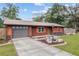 Home's exterior with gray garage door and landscaping at 1335 Ne 33Rd St, Ocala, FL 34479