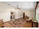 Living area with hardwood floors, ceiling fan, and open concept to kitchen at 1335 Ne 33Rd St, Ocala, FL 34479
