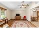 Living room with hardwood floors, ceiling fan, and views into dining area at 1335 Ne 33Rd St, Ocala, FL 34479