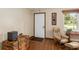 Bright living room with hardwood floors, ceiling fan and a comfortable recliner at 1335 Ne 33Rd St, Ocala, FL 34479