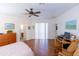 Main bedroom with wood floors, ceiling fan, and views of the backyard at 15659 Sw 13Th Cir, Ocala, FL 34473