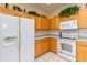 Kitchen boasts oak cabinets, white appliances, and a spacious layout at 15659 Sw 13Th Cir, Ocala, FL 34473