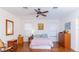 Spacious bedroom with wood floors, ceiling fan, and ample closet space at 15659 Sw 13Th Cir, Ocala, FL 34473