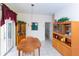 Bright dining area with wood table and chairs, built-in hutch and cabinet, and access to hallway at 15659 Sw 13Th Cir, Ocala, FL 34473