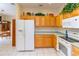 Well-equipped kitchen with oak cabinets, white appliances, and ample counter space at 15659 Sw 13Th Cir, Ocala, FL 34473