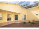 Bright, covered patio with a unique stone-patterned walkway, surrounded by landscaping at 15659 Sw 13Th Cir, Ocala, FL 34473