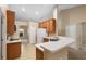 Kitchen with wood cabinets, white appliances, and breakfast bar at 3107 Ne 24 Pl, Ocala, FL 34470