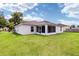 Large backyard with grassy lawn and screened porch at 3107 Ne 24 Pl, Ocala, FL 34470