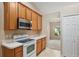 View of kitchen with stainless steel appliances and wood cabinets at 3107 Ne 24 Pl, Ocala, FL 34470