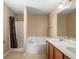 Bathroom with double sinks, bathtub, and shower at 3107 Ne 24 Pl, Ocala, FL 34470